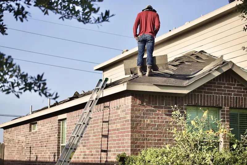 Professional roofer working on a residential roof in Quantico Base